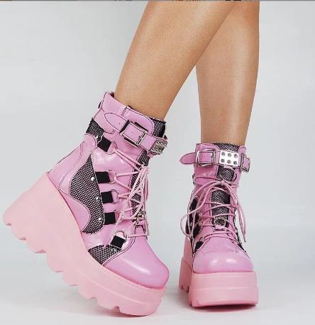Woman wearing pink platform wedge mid-calf boots