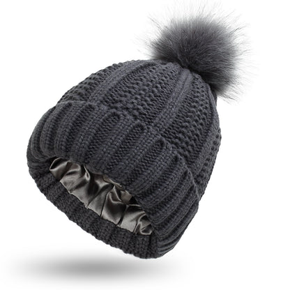 Women's knit beanie with faux fur pom pom