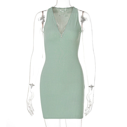 Woman wearing green and pink striped knit sleeveless mini dress
