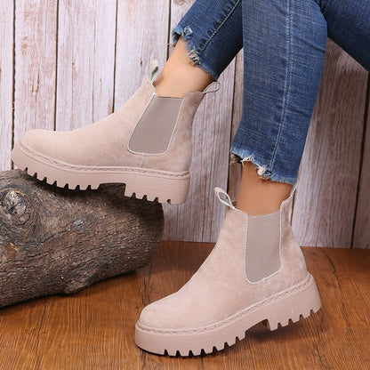 Woman wearing black short Martin boots with jeans