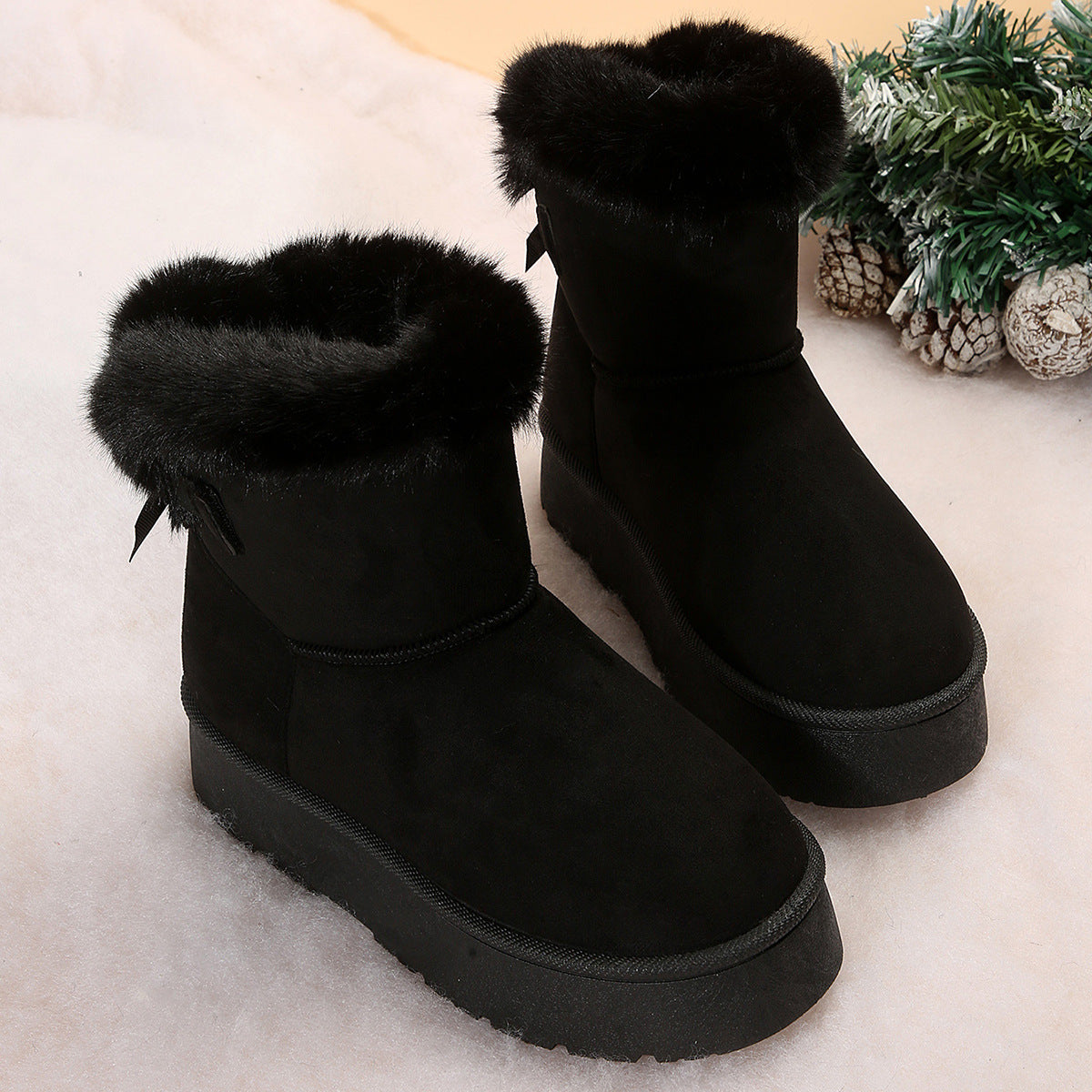 Women's black bow detail mid-top snow boots with plush lining