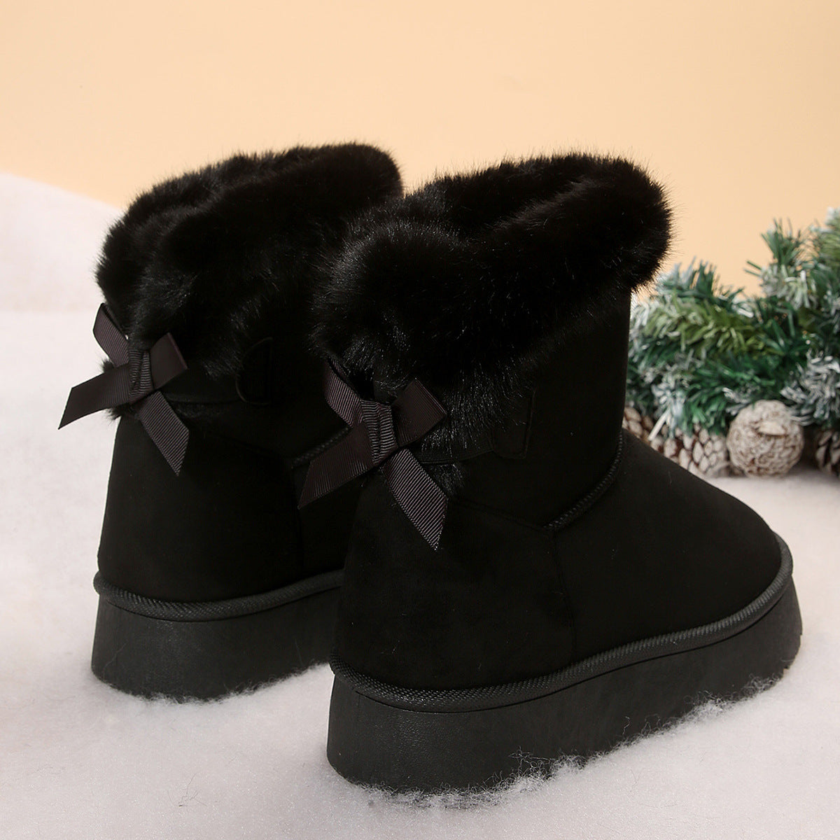 Women's black bow detail mid-top snow boots with plush lining