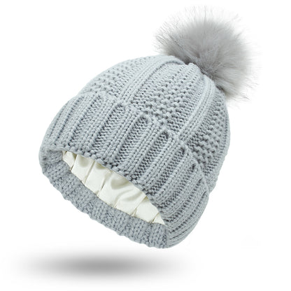 Women's knit beanie with faux fur pom pom