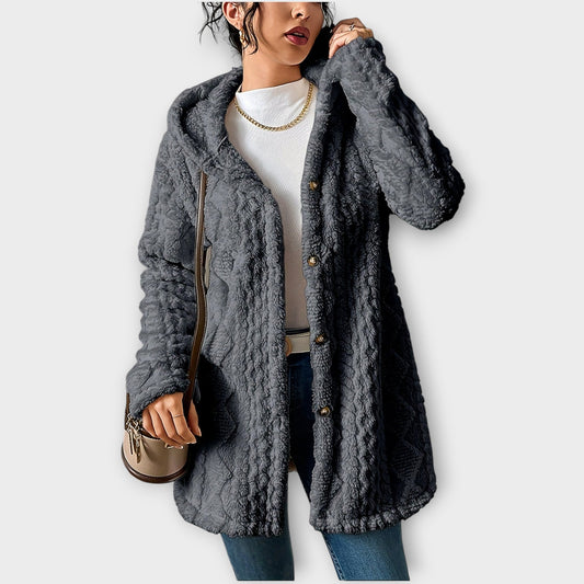 Woman wearing textured hooded winter jacket with relaxed fit