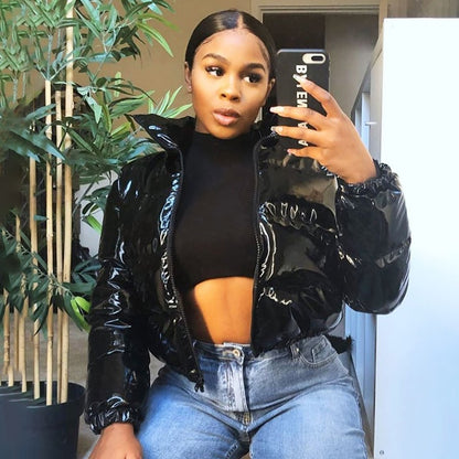 Woman wearing black faux leather puffer jacket with zip front
