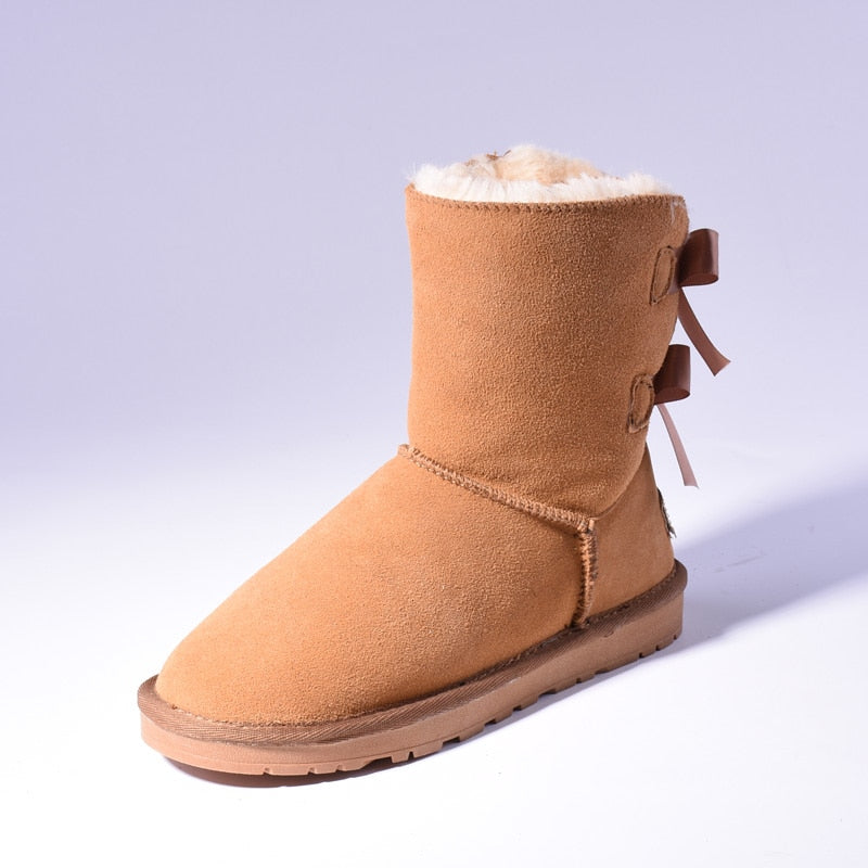 Women's mid-calf slip-on snow boots with bow detail