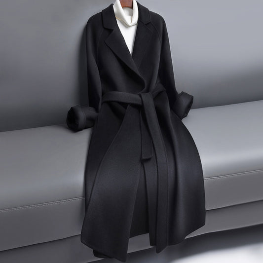 Woman wearing long wool winter coat with belt