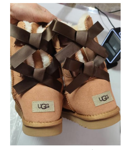 Women's mid-calf slip-on snow boots with bow detail