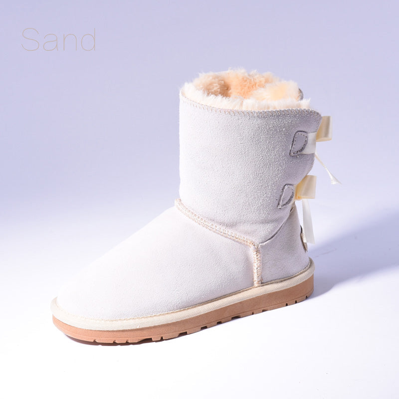 Women's mid-calf slip-on snow boots with bow detail