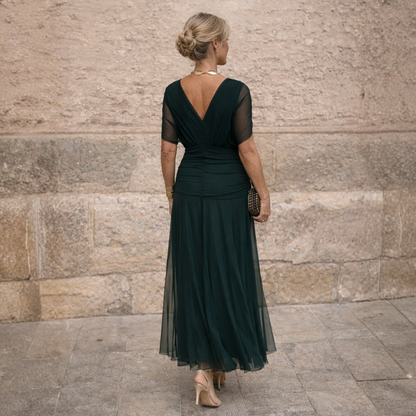 Woman wearing long flowing maxi dress with V-neck