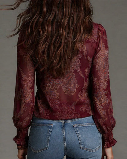 Woman wearing V-neck ruffle sleeve blouse with print