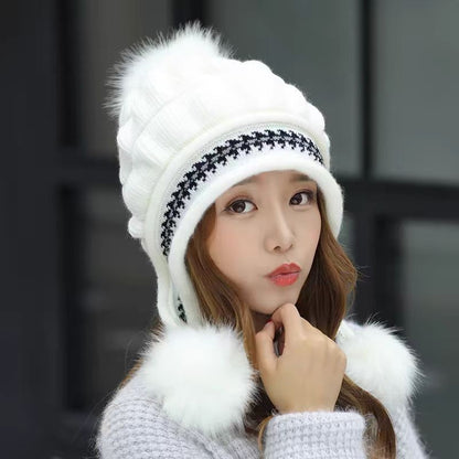 Women's knit beanie with ear flaps and pompom