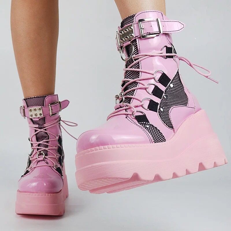 Woman wearing pink platform wedge mid-calf boots