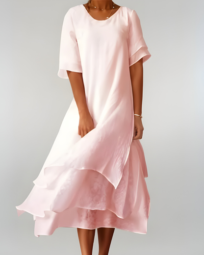 Woman wearing flowing maxi dress with open neckline