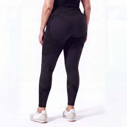 Woman wearing fitted 3D sculpting leggings in studio
