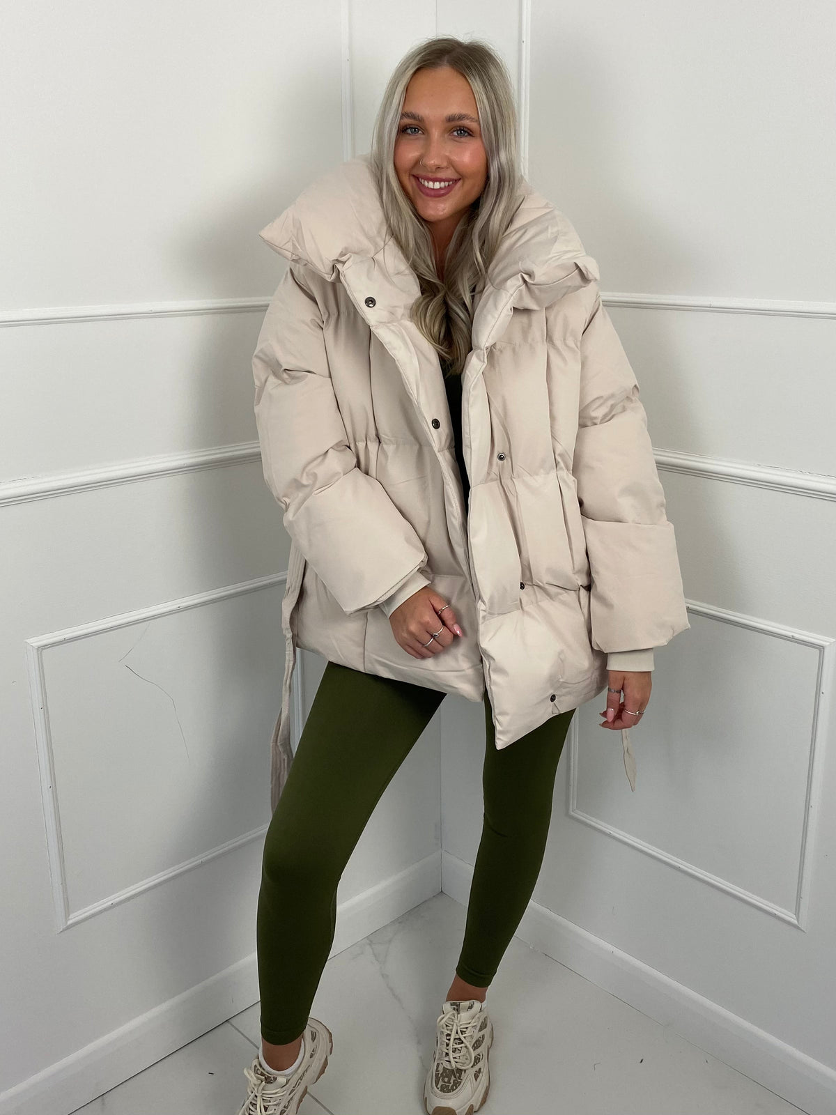 Woman wearing quilted puffer jacket with belt