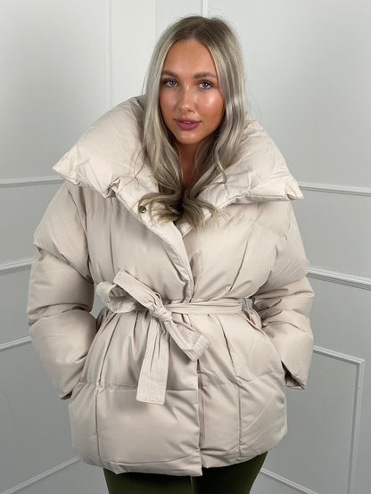 Woman wearing quilted puffer jacket with belt