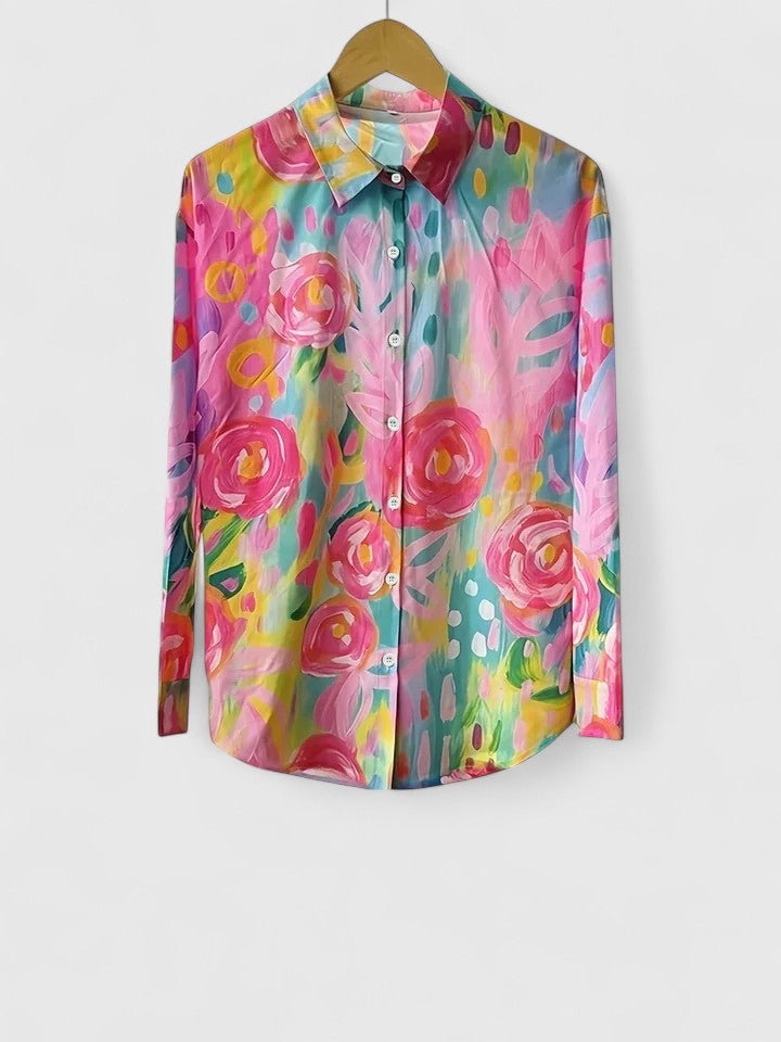 Woman wearing printed button-up blouse in bold colors