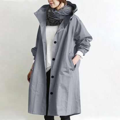 Woman wearing long hooded coat with front buttons