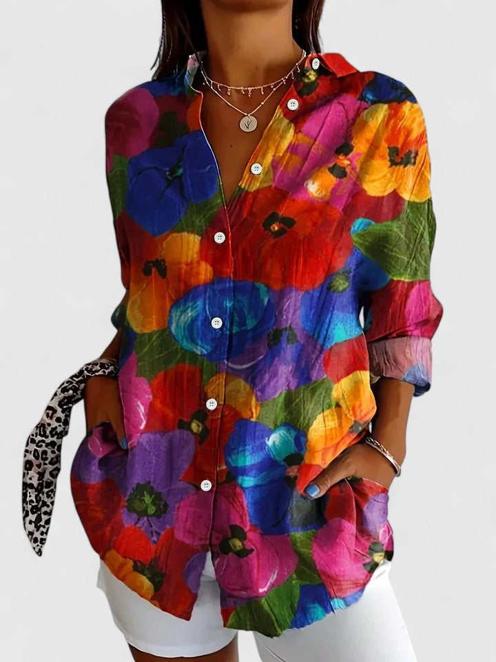 Woman wearing printed button-up blouse in bold colors