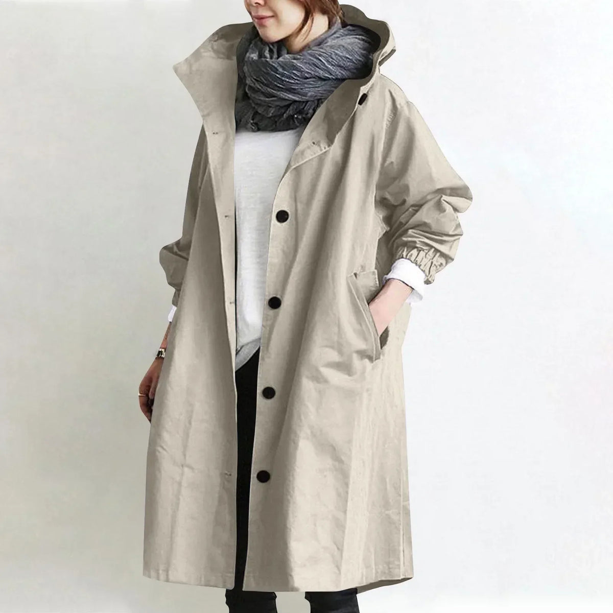 Woman wearing long hooded coat with front buttons