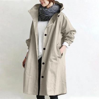 Woman wearing long hooded coat with front buttons