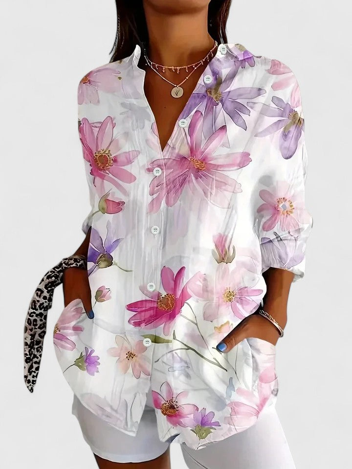 Woman wearing printed button-up blouse in bold colors