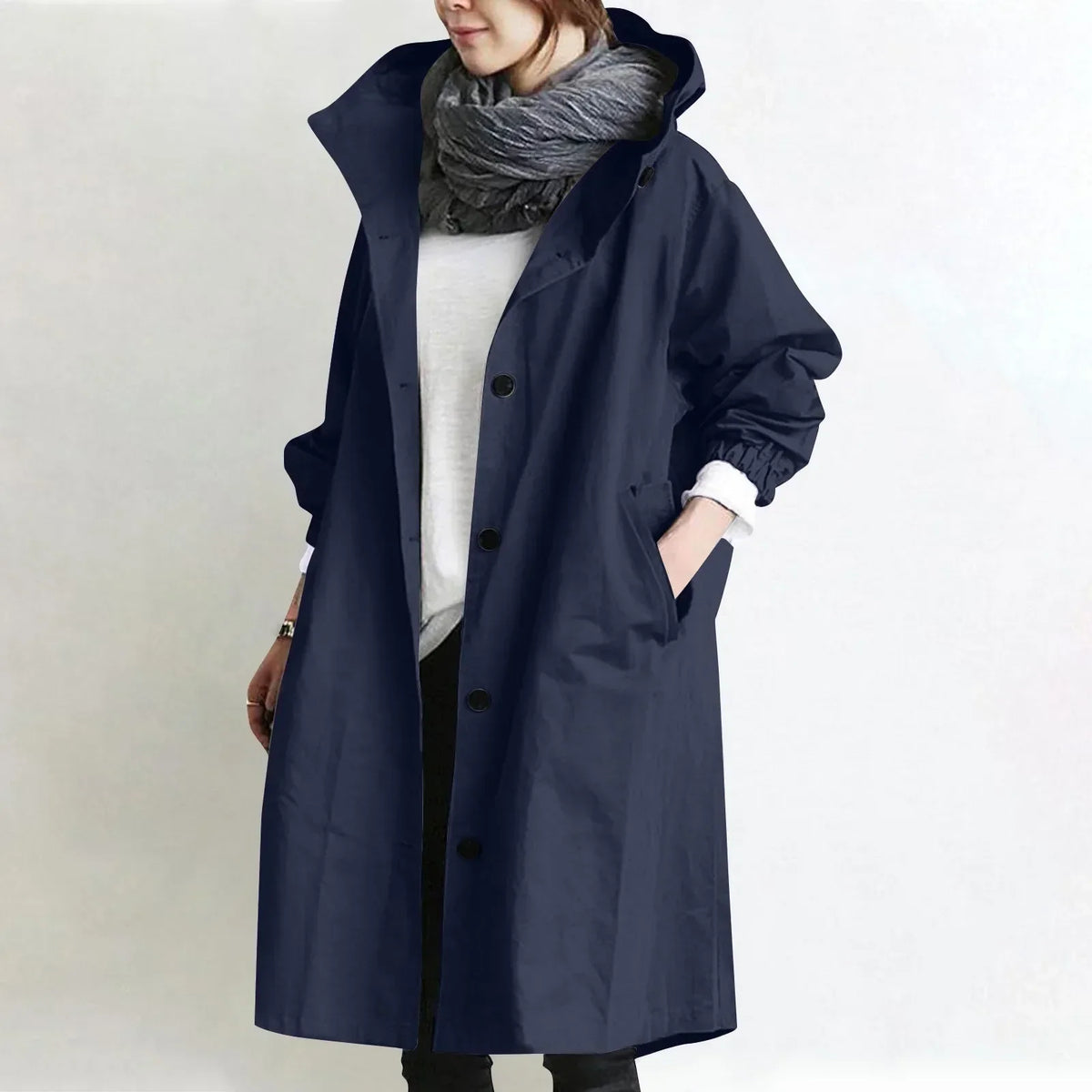 Woman wearing long hooded coat with front buttons