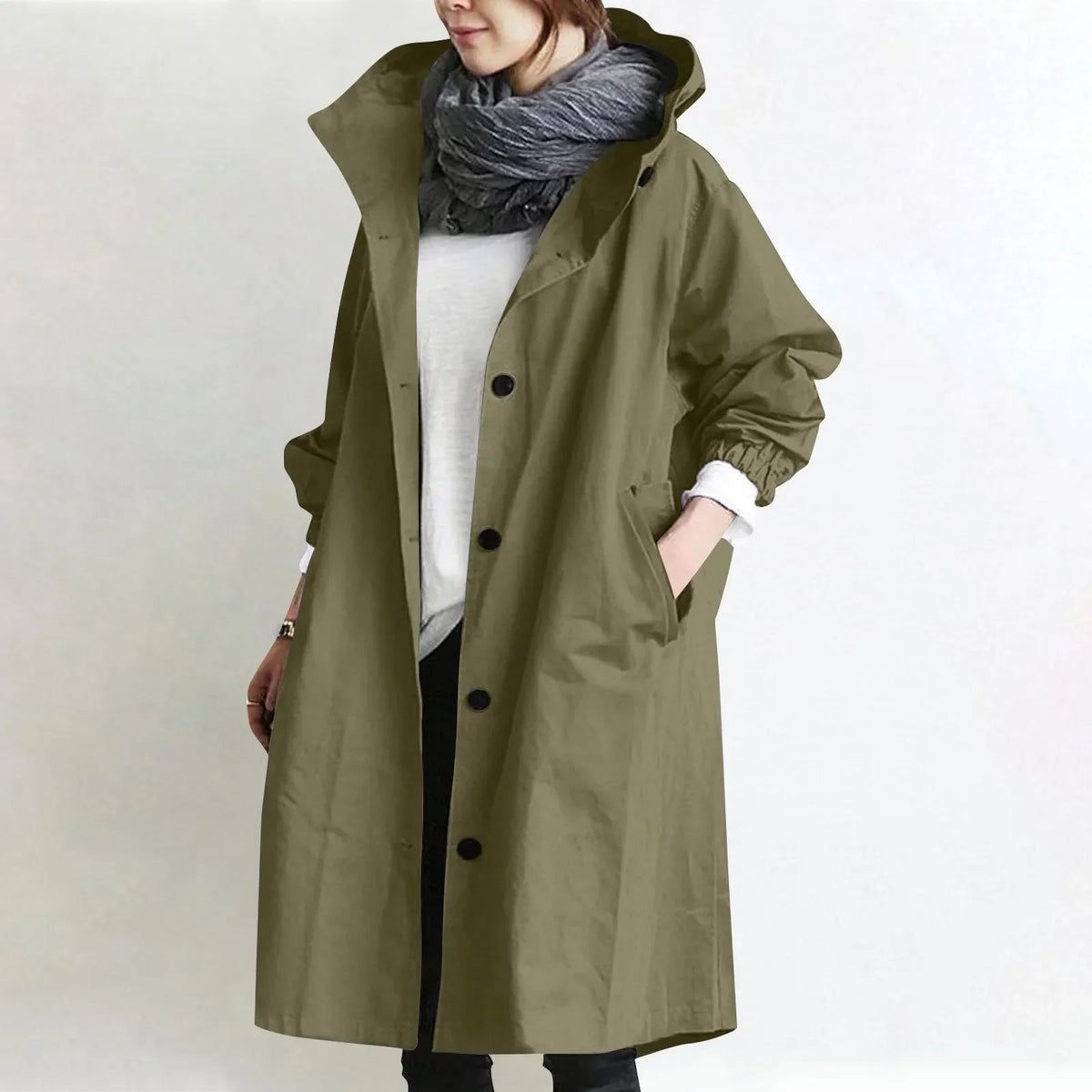 Woman wearing long hooded coat with front buttons