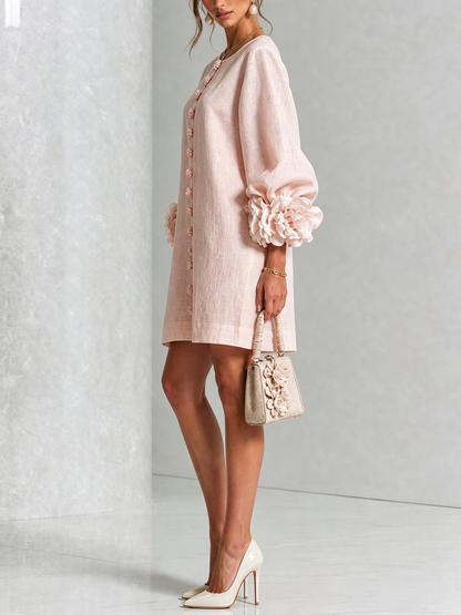 Woman wearing pink floral mini dress with rosette cuffs