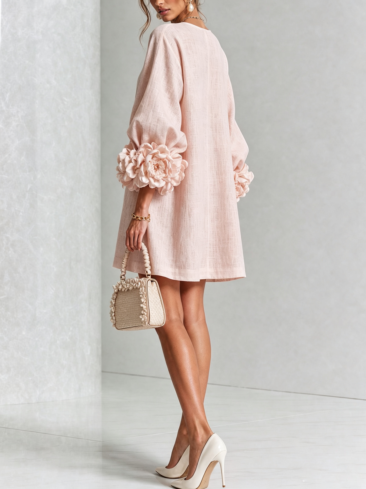 Woman wearing pink floral mini dress with rosette cuffs