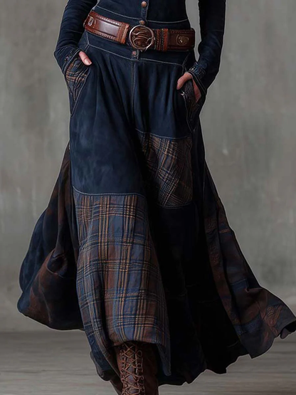Woman wearing navy patchwork maxi dress with matching belt