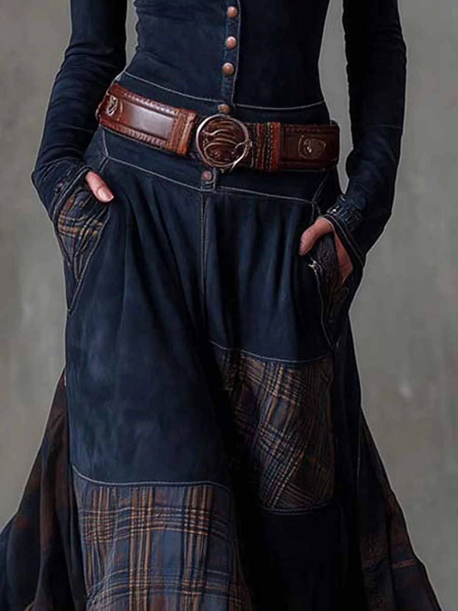 Woman wearing navy patchwork maxi dress with matching belt