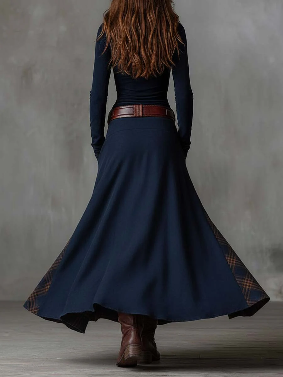 Woman wearing navy patchwork maxi dress with matching belt