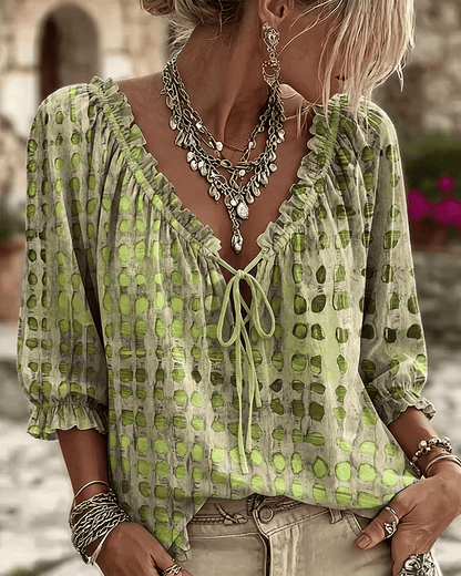Woman wearing polka dot blouse with V-neck and puff sleeves