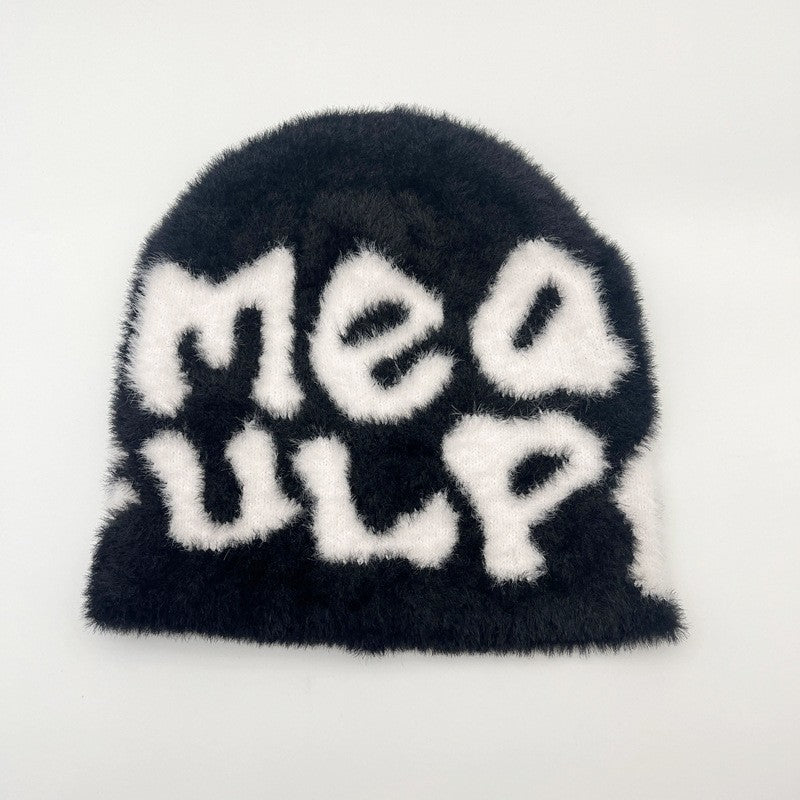 Woman wearing knit beanie hat in winter outfit