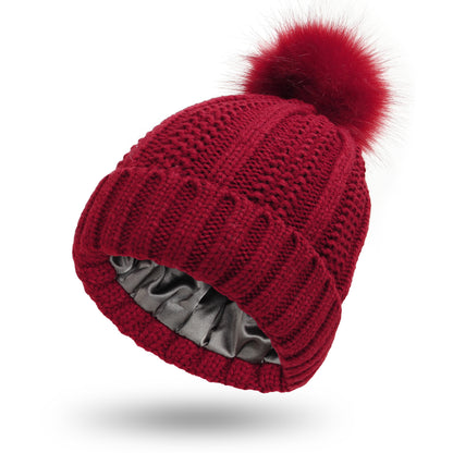 Women's knit beanie with faux fur pom pom