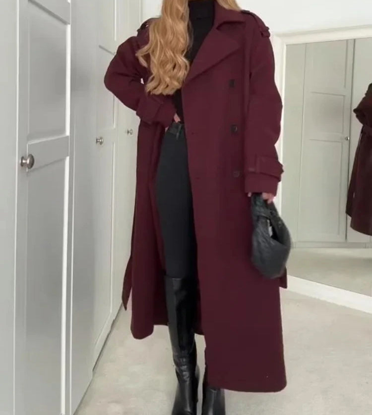 Woman wearing wine red double-breasted long coat with belt