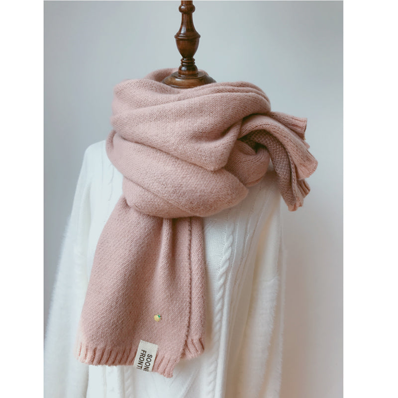 Woman wearing long winter scarf in imitation cashmere fabric