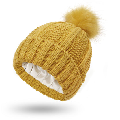 Women's knit beanie with faux fur pom pom
