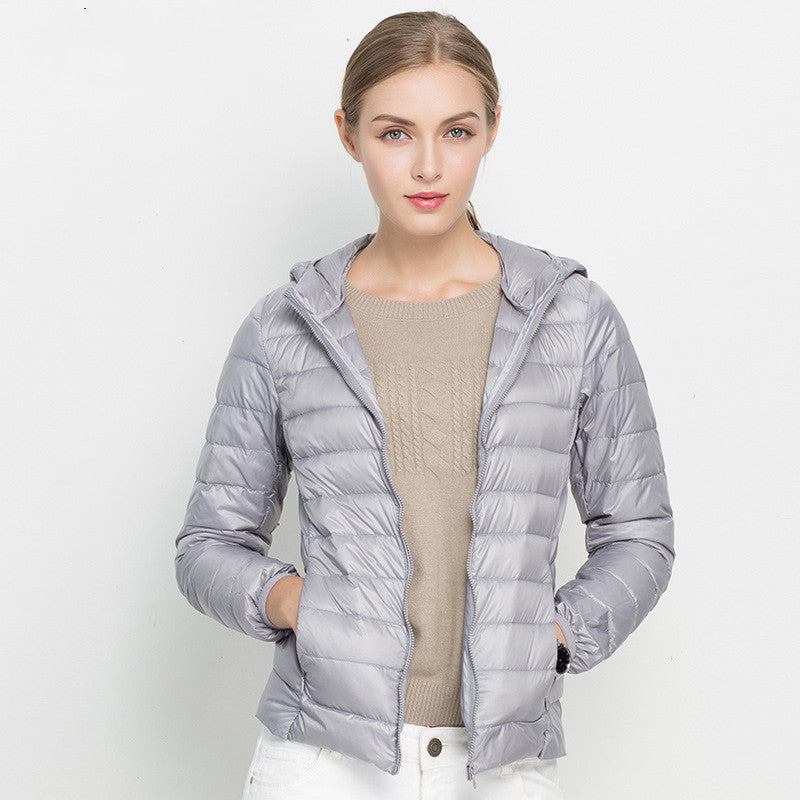 Woman wearing short hooded down jacket with zip front