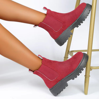 Woman wearing black short Martin boots with jeans