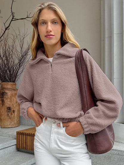 Woman wearing gray lamb fleece jacket with jeans
