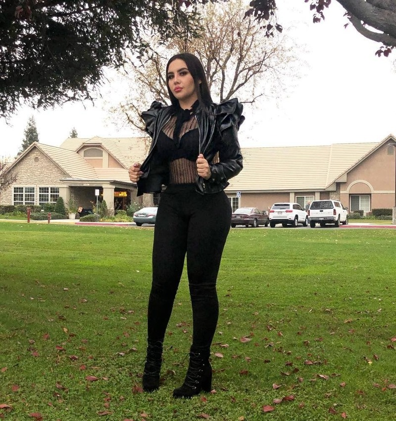 Woman wearing black leather jacket with ruffle edge