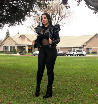 Woman wearing black leather jacket with ruffle edge
