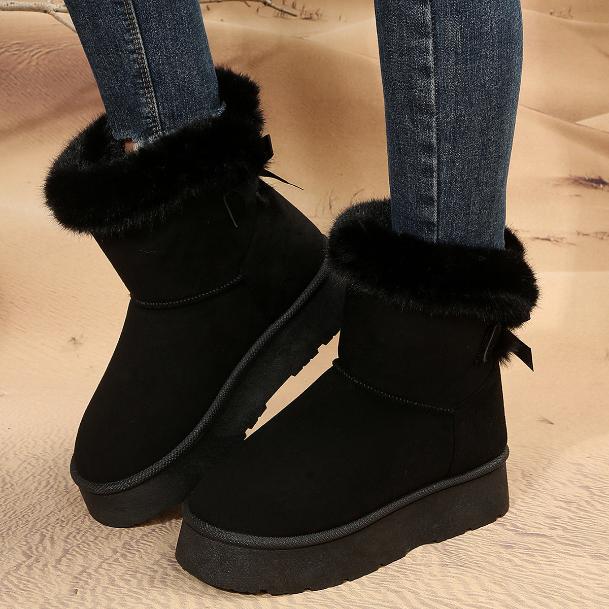 Women's black bow detail mid-top snow boots with plush lining