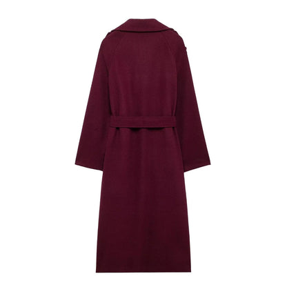 Woman wearing wine red double-breasted long coat with belt