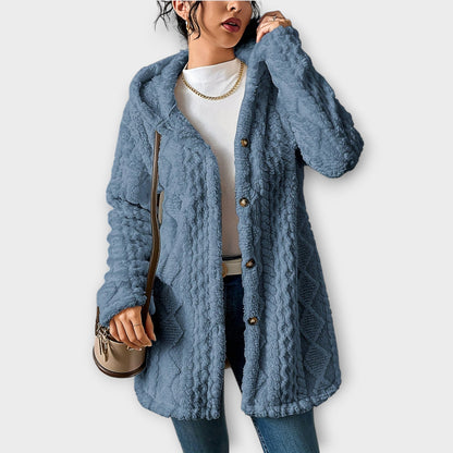 Woman wearing textured hooded winter jacket with relaxed fit