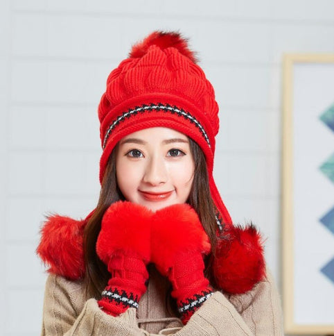 Women's knit beanie with ear flaps and pompom