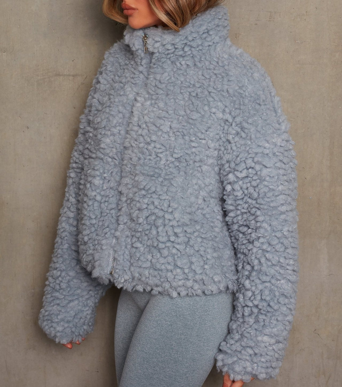 Woman wearing short open-front cardigan jacket indoors